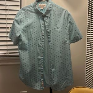 Large slim fit Penguin turquoise shirt with little flamingos.